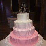 pink ombre cake with wire bike cake topper
